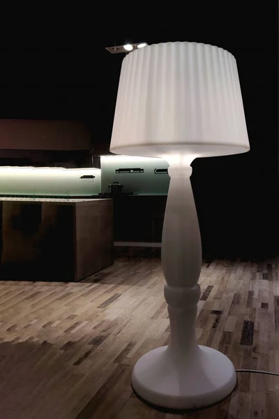 Floor Lamp. An Illuminated Lamp in a Room.