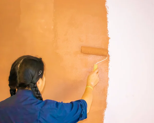Happy Ukrainian Woman Painting Interior Wall With Paint Roller in New House.