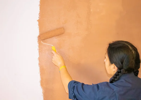 Happy Ukrainian Woman Painting Interior Wall With Paint Roller in New House.