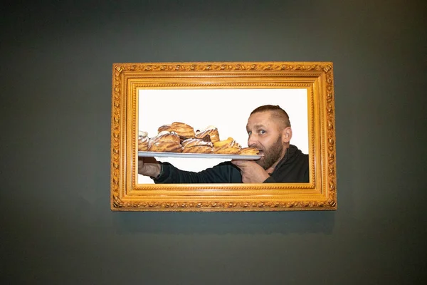 グルトニーと食べ過ぎの概念 灰色の背景に囲まれた甘いものを食べる男の肖像画 デザートが多い — ストック写真