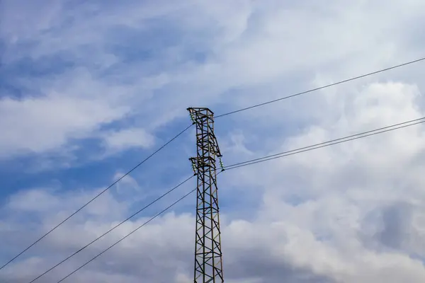 stock image Electrical Towers. Power Line on the Background of a Blue Sky with Clouds. The Concept of Light and Electricity Supply.