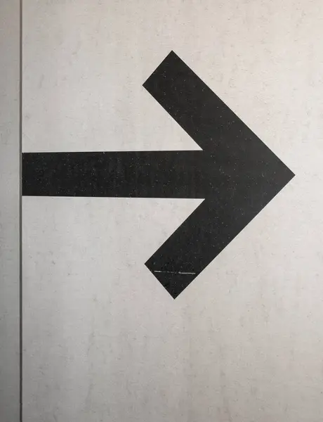 Arrow symbol painted on the wall.