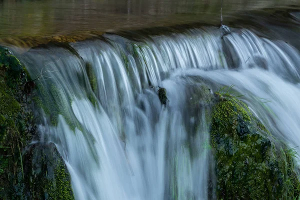 stock image Waterfall close up, water flow over mossy rock