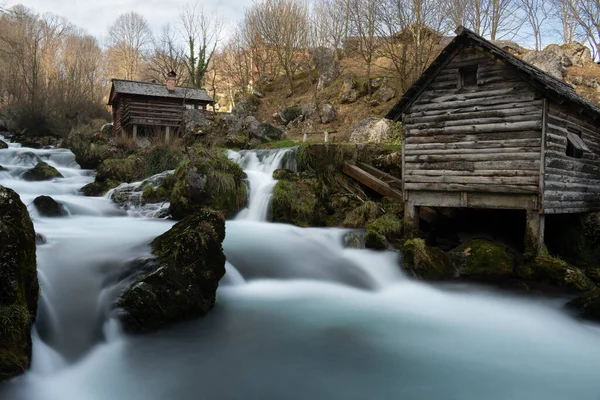 stock image Mountain river with mossy rocks and wooden watermills in long exposure, river Krupa in Krupa na Vrbasu