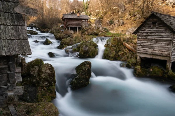 Stock image Mountain river with mossy rocks and wooden watermills in long exposure, river Krupa in Krupa na Vrbasu