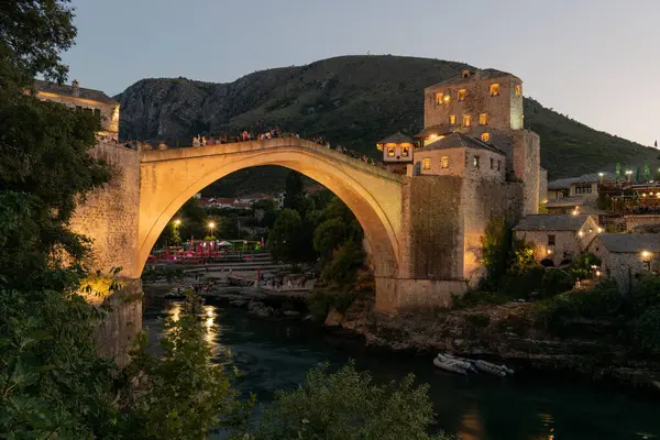 Mostar 'daki Neretva nehri üzerindeki eski köprü alacakaranlıkta aydınlandı.