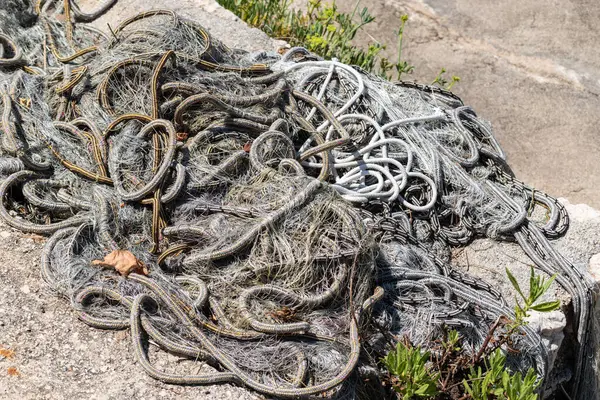 stock image Fishing net on concrete dock, fisherman's equipment