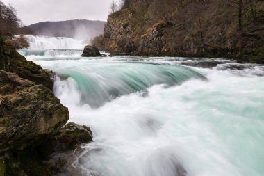 Waterfall and cascade on Una river, water sprays and flows in motion blur, turquoise colour clipart