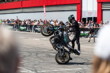 Dublör sürücüsü, Banja Luka 'da moto festivalinde motosikletini sürüyor.