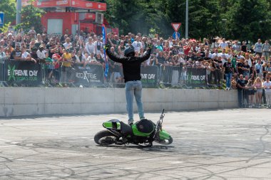 Dublör, Banja Luka 'daki moto festivalinde motosiklet üzerinde duran seyirciyi selamladı