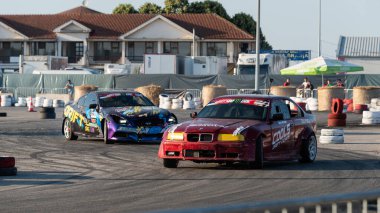 Yanan lastiklerden gelen dumanlar yüzünden araba raylarda sürükleniyor.