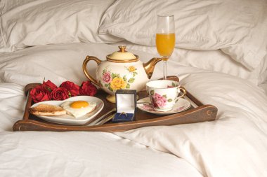 Valentines  day  romantic  breakfast  in  bead with a  diamond  ring  proposal 