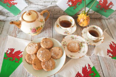 Celebrating  St  Davids  Day  wales   With  national  flag   daffodils  and  home  bake  welsh cakes  March