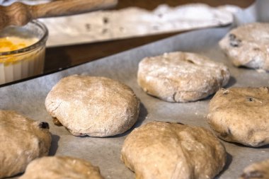 Pişmemiş meyveli çörekler tepside fırını bekliyor. 