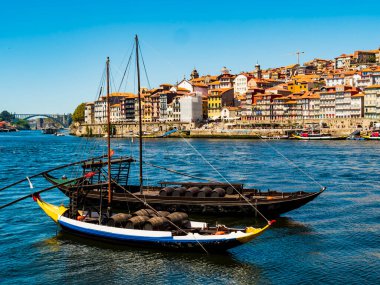 Incredible view of Porto, with its coloured houses and typical boats on the banks of Douro river, Portugal
