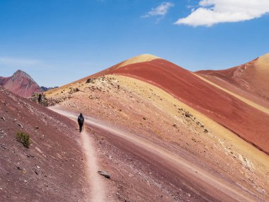 Tourists walking down the Red Valley (valle rojo) after visiting the Rainbow Mountain, Cusco region, Peru