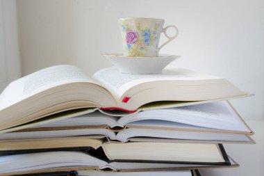 stack of books with cup of coffee front view clipart