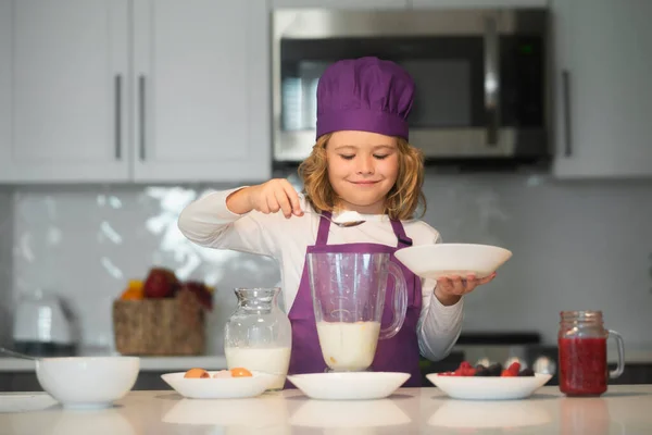 stock image Chef kid preparing tasty food at kitchen. Kids are preparing the dough, bake cookies in the kitchen