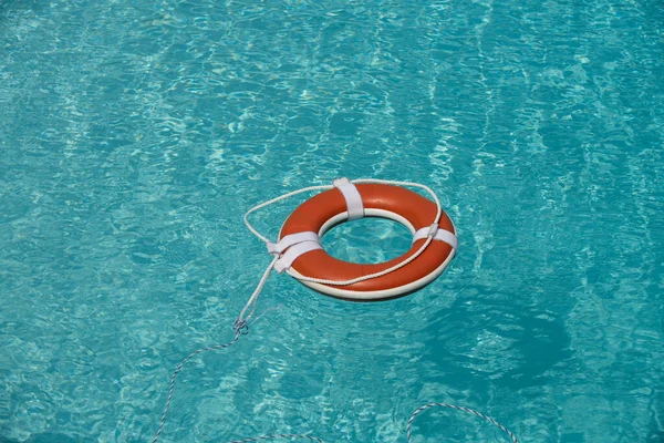 Drowning in water catch lifebuoy. Safety and urgent help. Resque needed. Life buoy floating in pool