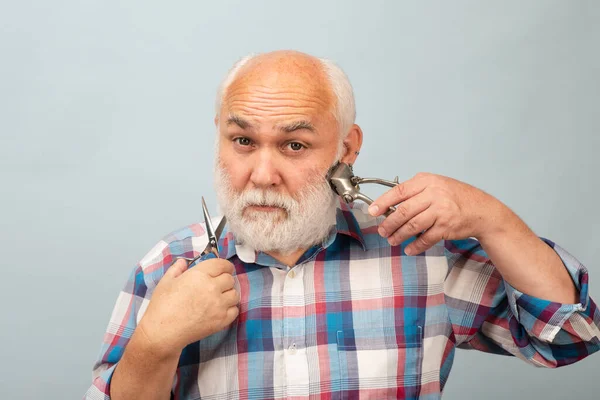 Middle aged hairdresser man. Barber scissors and straight razor hair clipper, Vintage barber shop, shaving. Portrait old bearded man. Vintage barbershop