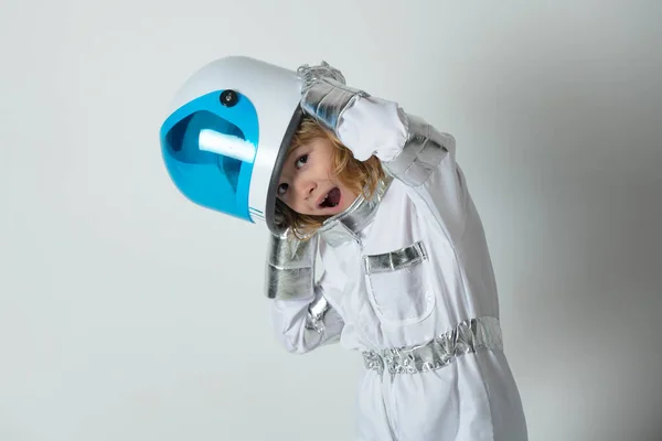 Portrait of wondered little astronaut in helmet and protective space suit. Funny little boy astronaut
