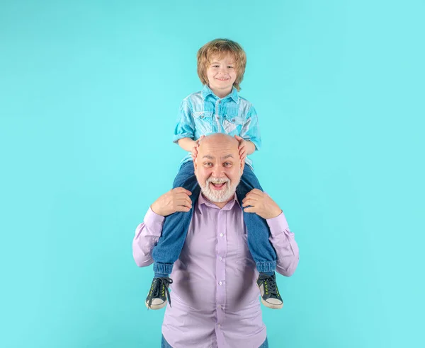 年轻的孙子和老祖父的背脊背 滑稽的脸孤立在蓝色的工作室 爷爷和可爱的男孩与滑稽的脸 — 图库照片