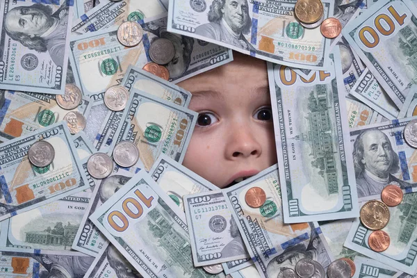 Kids head in money. Fun kid face on dollars money