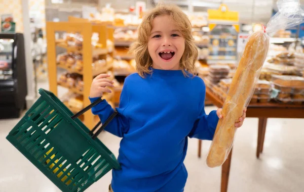 Kid choosing food in grocery store or a supermarket. Fruit and vegetable