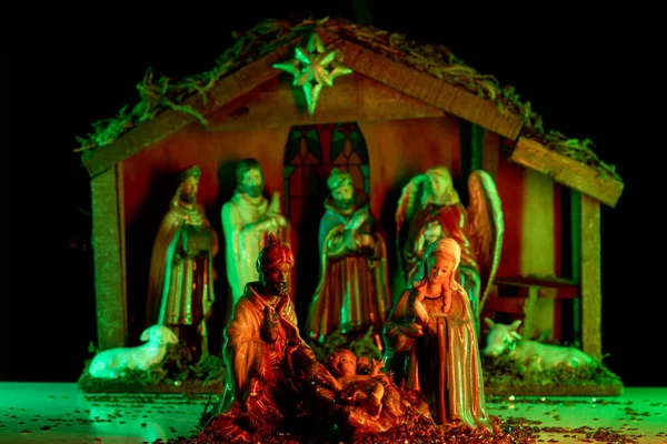 Nativity scene with figures. Christmas Manger scene with figures of Jesus, Mary, Joseph, sheep and magi. Statuettes of the Nativity