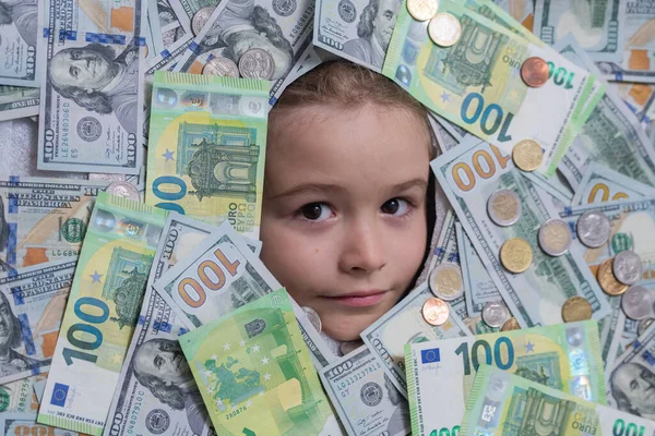 Euro and dollar concept. Kids how to be rich. Child with dollar bills near face. Financial independence and ability to earn a lot of money. Shopping and financial concept