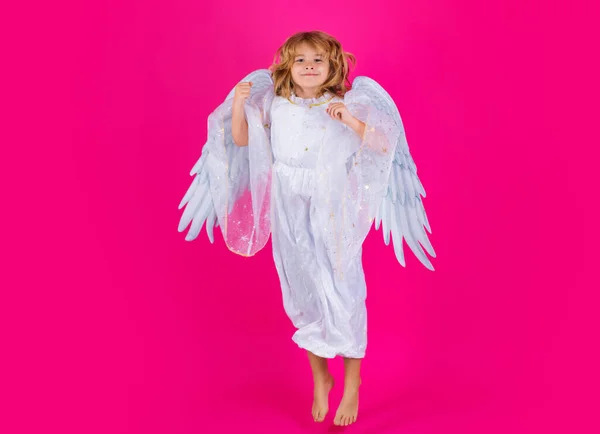 Angel child jump, kids jumping, full body in movement. Little angel. Portrait of cute kid with angel wings isolated on studio background. Little angel, valentines day. Angelic kids