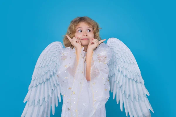 Cute angel kid, studio portrait. Blonde curly little angel child with angels wings, isolated background