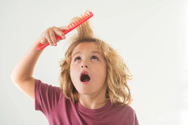 Funny kids hairstyle. Child with a comb and problem hair. Kids shampoo. Hair does not comb without a conditioner balm