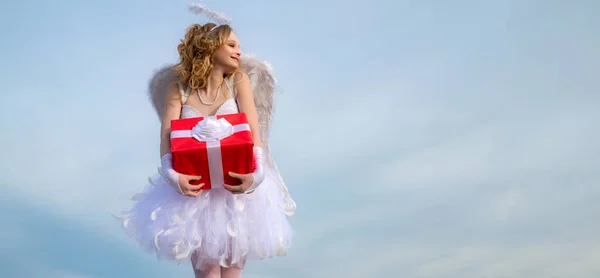 Banner. Angel teenager girl with white wings. Cupid angel with gift in valentine day Valentine concept. Happy teenage angel girl. Child with angelic character
