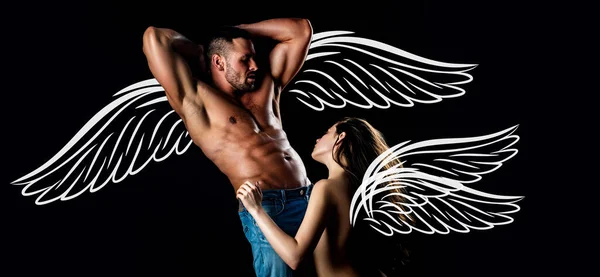 Angels couple, valentines day photo banner. Sexy muscular naked man and female hands undress his jeans on black background.