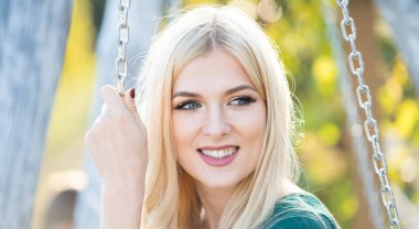 Portrait of sensual woman in spring background. Banner for website header. Closeup face of young stylish woman. Woman with romantic smile. Pretty lady enjoying summer outdoors