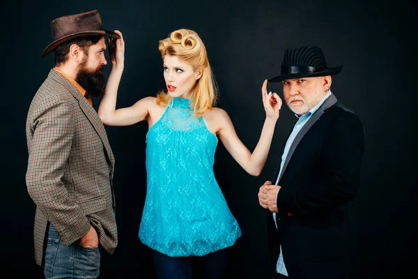Woman choose between two men. Funny gangsters with young woman. Fashion old grandpa in suit with young son and girl, isolated background. old and young
