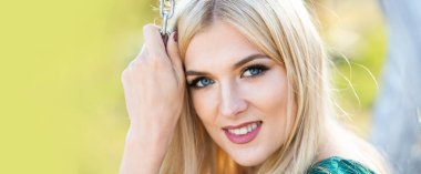 Portrait of sensual woman in spring background. Banner for website header. Spring romantic casual blonde romantic woman portrait. Woman with romantic smile. Young woman on sunny summer day