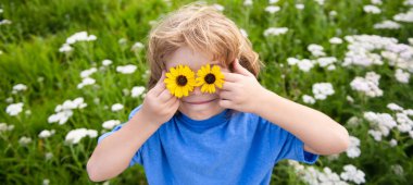 Close up portrait of cute child outdoors. Spring banner for website header. Kids having fun in spring park. Child on green grass