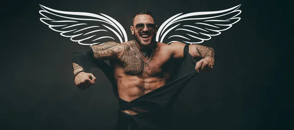 Naked muscular angel. Photo banner of sexy man with wings for valentines day. Angry guy. Fashion brutal guy with sexy body ripped shirt. Sexy man with muscular body and bare torso