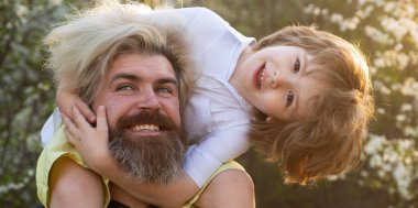 Dad and child boy hugging piggyback ride, spring banner. Father son relationships. Child hugging dad. Happy fathers day. Son shoulder ride. Friendly family