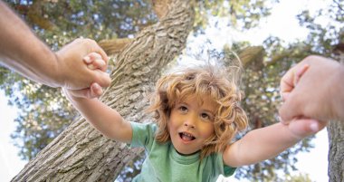 Fathers hand. Spring banner. Father helping son to climbing. Parent holds the hand of child