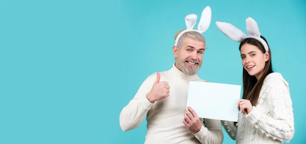 Happy Easter couple. Funny picture of funny couple with rabbit ears. Isolated, text, background and copy space. Panoramic web banner frame