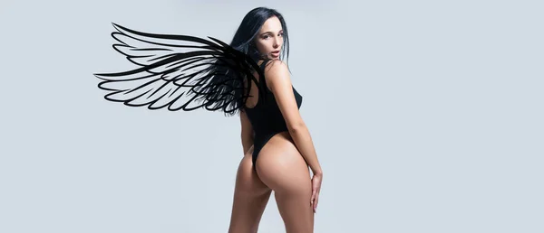 Sexy woman with angel wings. Valentines day banner of sexy model body. Fashionable woman on isolated studio background. High fashion portrait of young elegant woman, studio shot