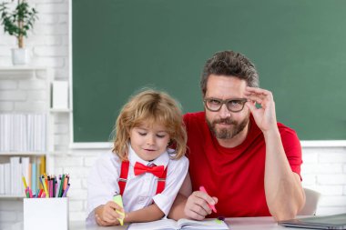 Back to school. Teacher and child learning at school classroom