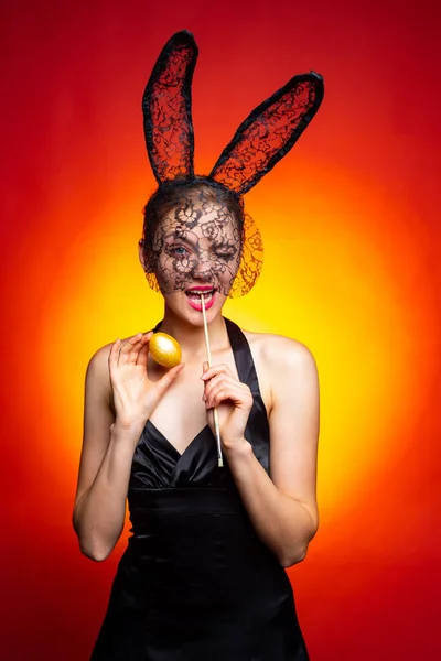 Happy young woman wearing bunny ears and having Easter Eggs. Bunny rabbit ears costume