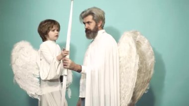 Valentine day with father and son aiming with bow, arrow shooting. Love family concept. Valentin man with angel wings. Valentines Day