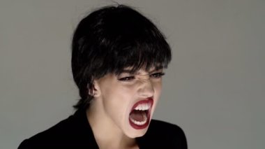 Shouting mouth, screaming face. Pretty girl shouting and screaming close up. Open screaming mouth