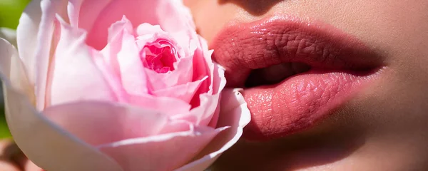 Lips and rose, close up spring banner. Lips closeup. Beautiful woman lips with spring rose