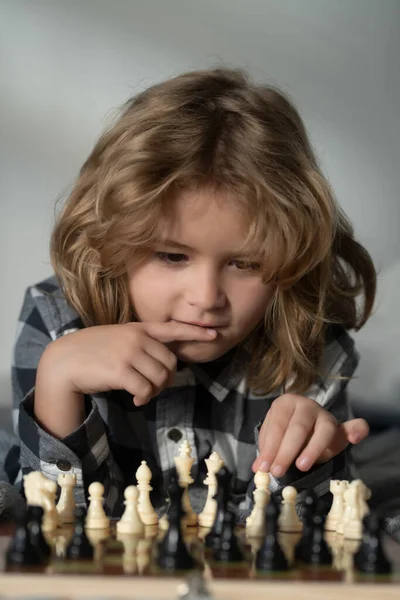Clever thinking child. Kid thinking about chess. The concept of learning and growing children. Chess, success and winning. Board logic game, kids hobby and lifestyle